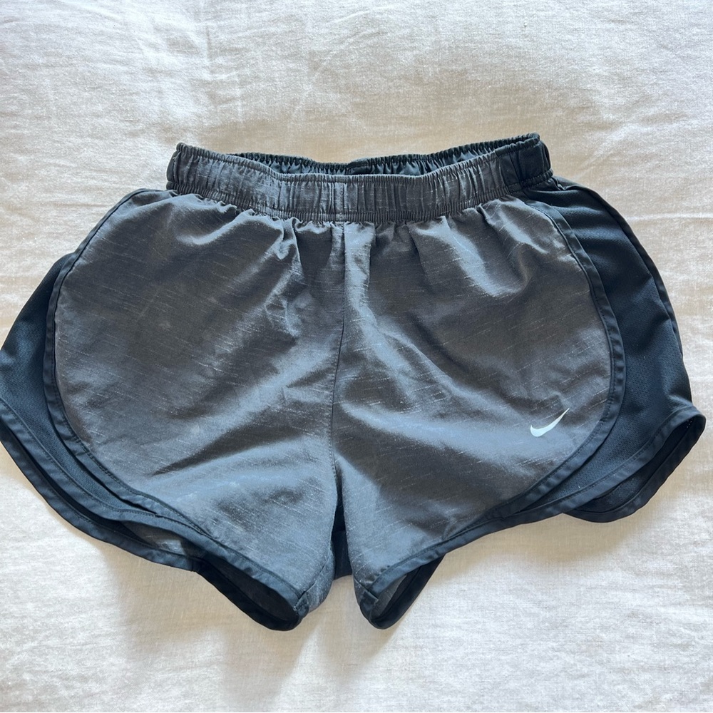Black and gray Nike dry fit running shorts.